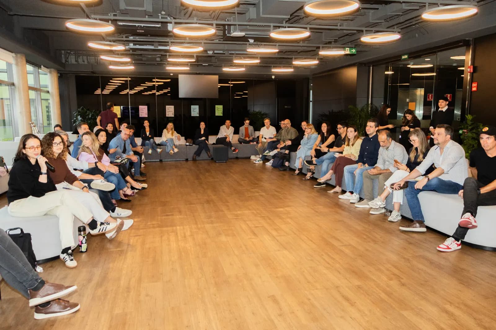 Participantes do GAN Business Club sentados em círculo durante o debate